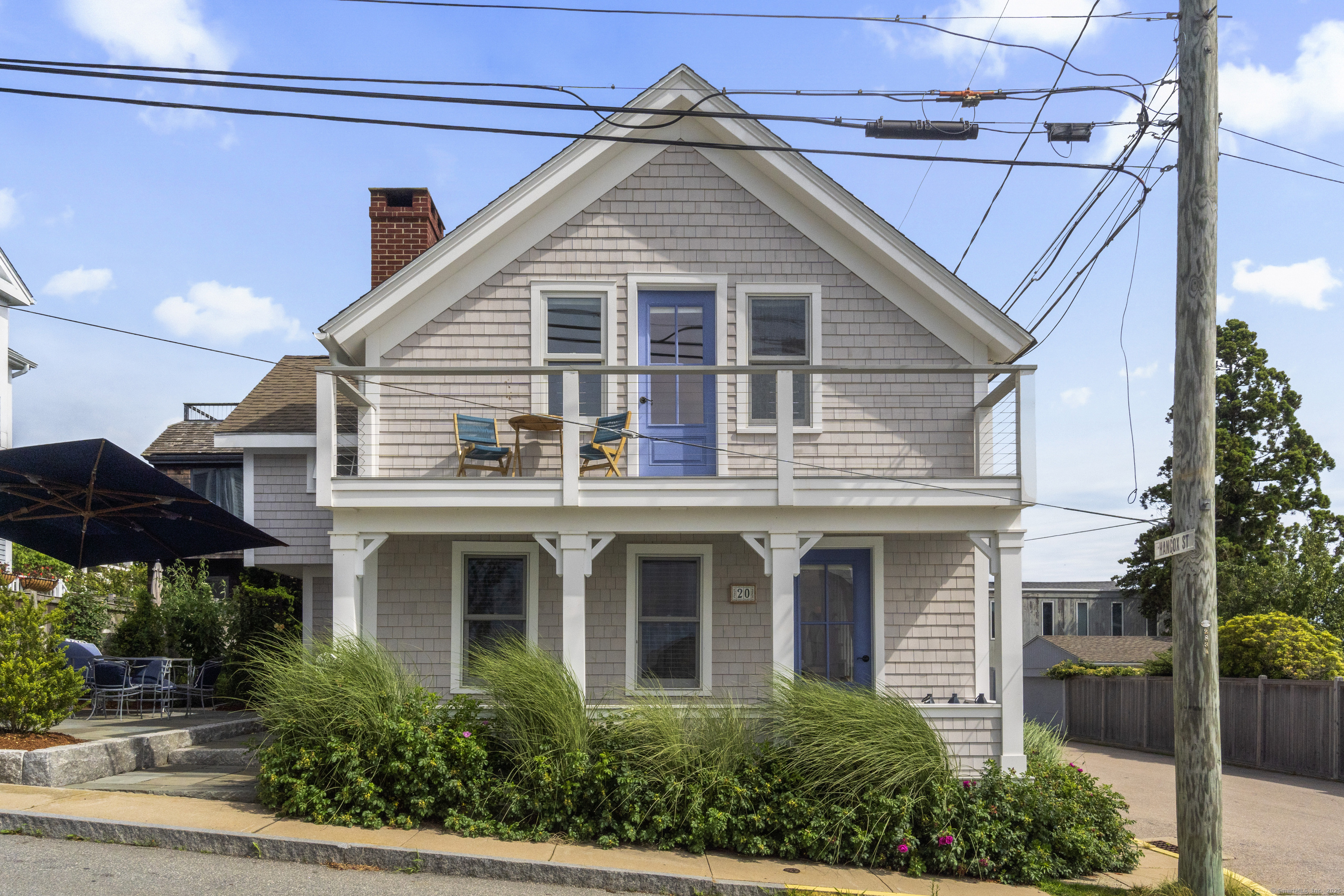 a front view of a house with yard and glass windows