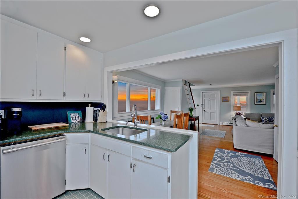20 Omega Street Stonington, CT 06378 - Photo 19 of 37 a kitchen with stainless steel appliances granite countertop a sink dishwasher stove and cabinets