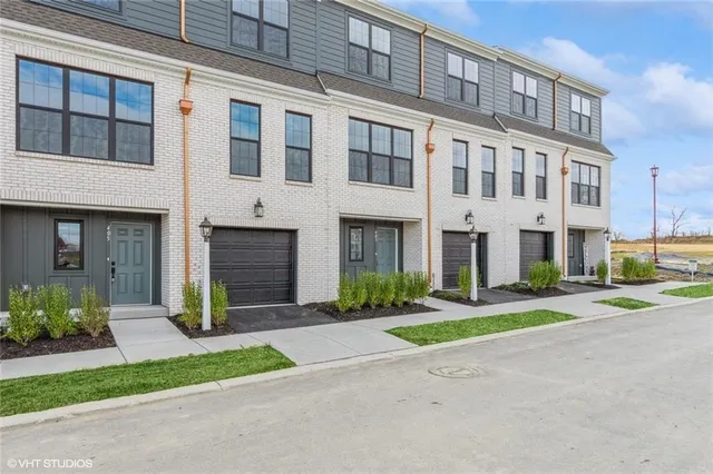 a view of a brick building next to a yard