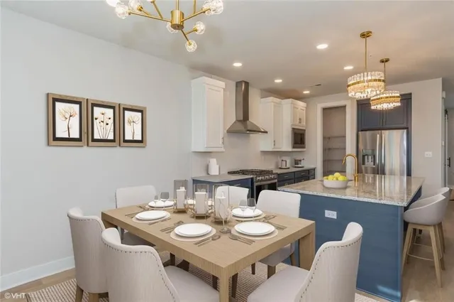 a kitchen that has a table and chairs in it