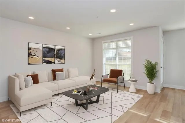 a living room with furniture and wooden floor