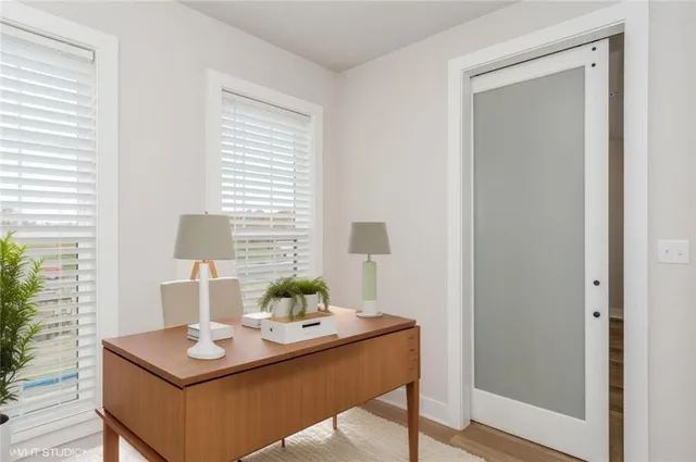 a view of a workspace with furniture and window