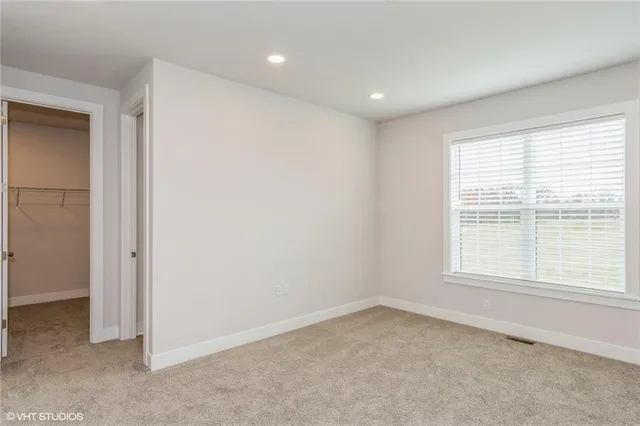 a bathroom with a toilet a sink a mirror a shower and vanity