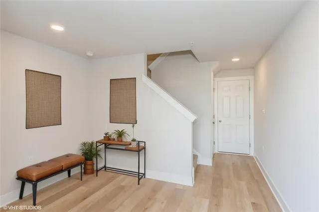 a view of a livingroom with furniture and stairs