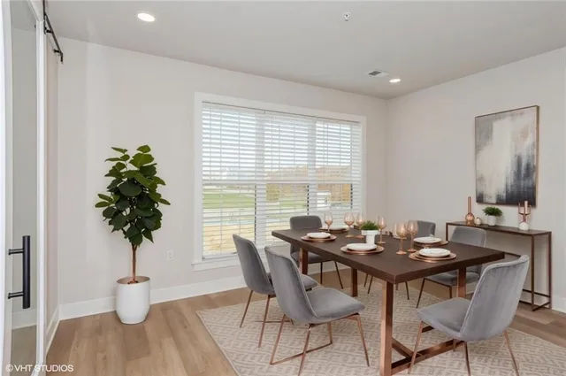a view of a dining room with furniture window and wooden floor