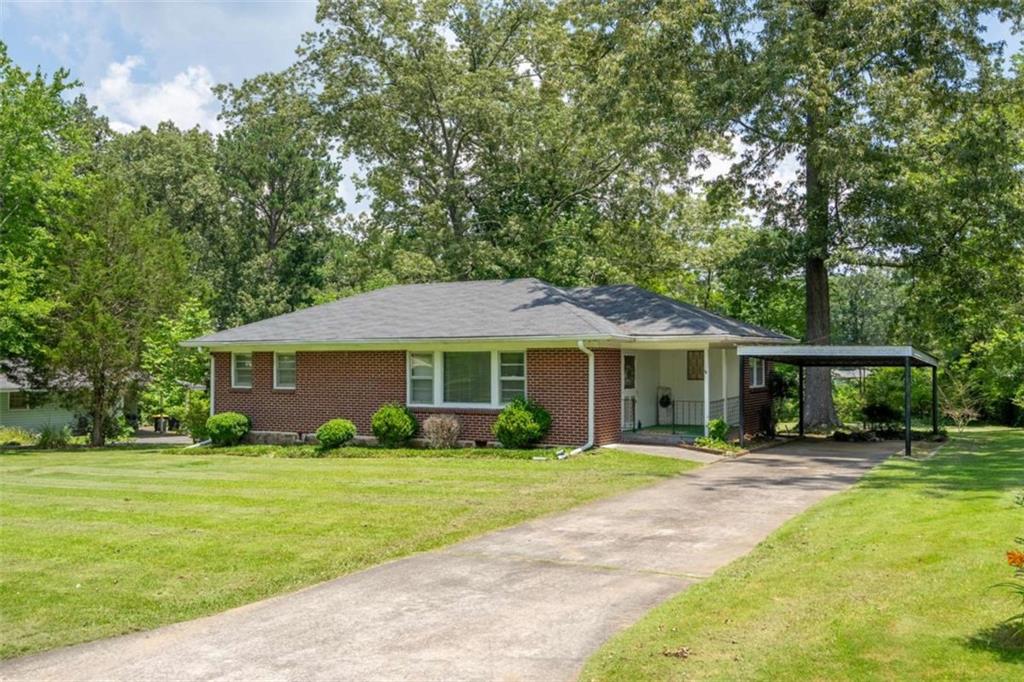 a front view of a house with yard patio and green space