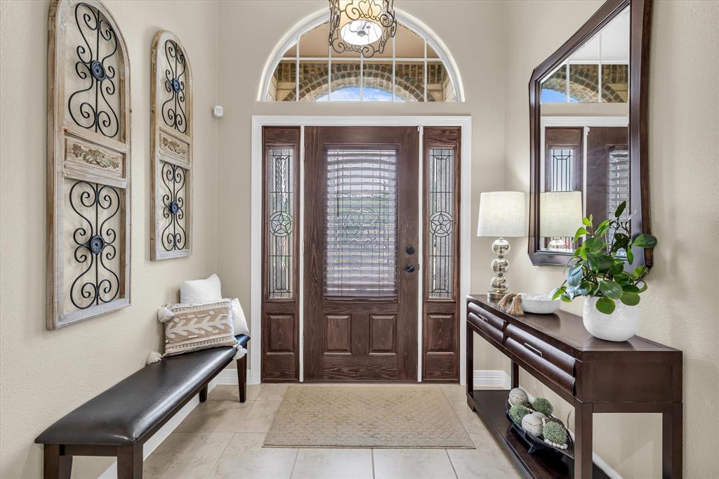 910 Springdale Lane Lorena, TX 76655 - Photo 4 of 39 Entryway featuring a dark wood front door with sidelights, transom window, and tile flooring