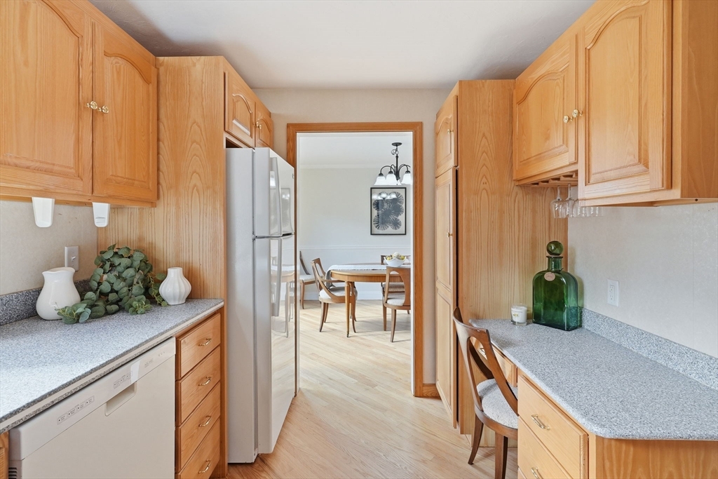 1032 Main Street, Unit 6 Millis, MA 02054 - Photo 13 of 42 a kitchen with stainless steel appliances a table and chairs