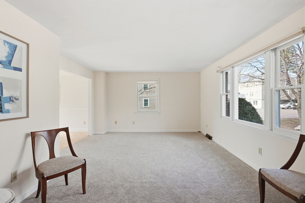 1032 Main Street, Unit 6 Millis, MA 02054 - Photo 3 of 42 a view of an empty room with a window and a kitchen