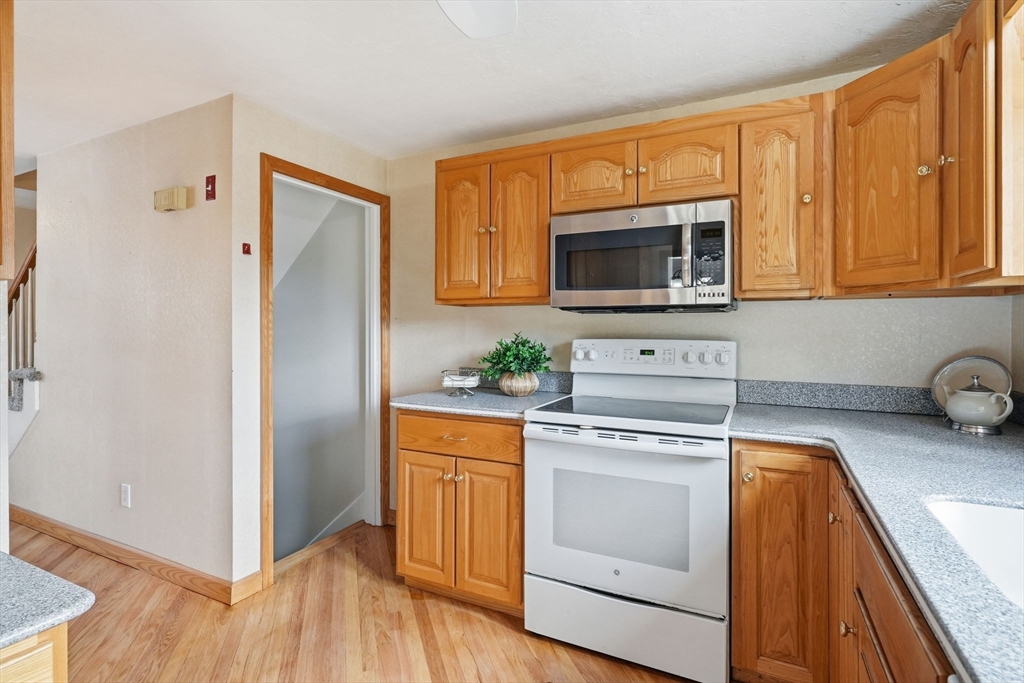 1032 Main Street, Unit 6 Millis, MA 02054 - Photo 10 of 42 a kitchen with stainless steel appliances granite countertop a refrigerator stove and sink