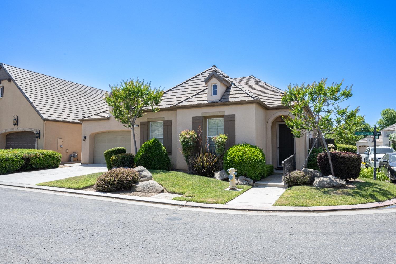 1778 Osmun Avenue Clovis, CA 93619 - Photo 1 of 35 a front view of a house with a yard and potted plants