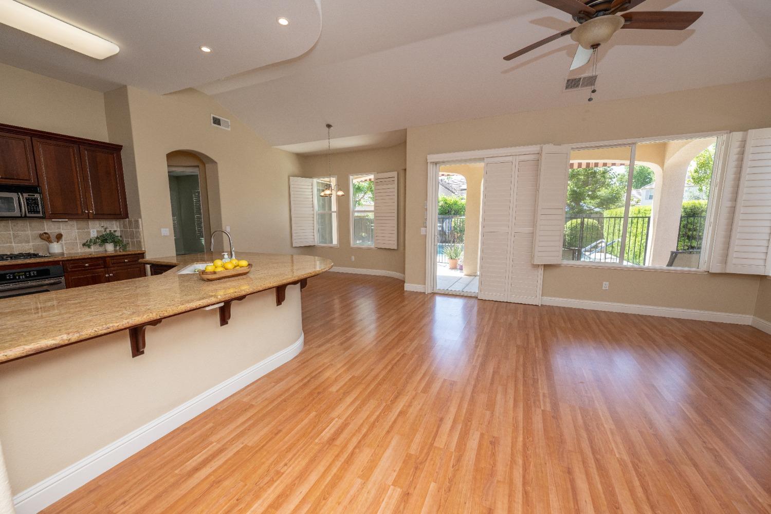 1778 Osmun Avenue Clovis, CA 93619 - Photo 11 of 35 a living room with stainless steel appliances granite countertop furniture wooden floor and a window