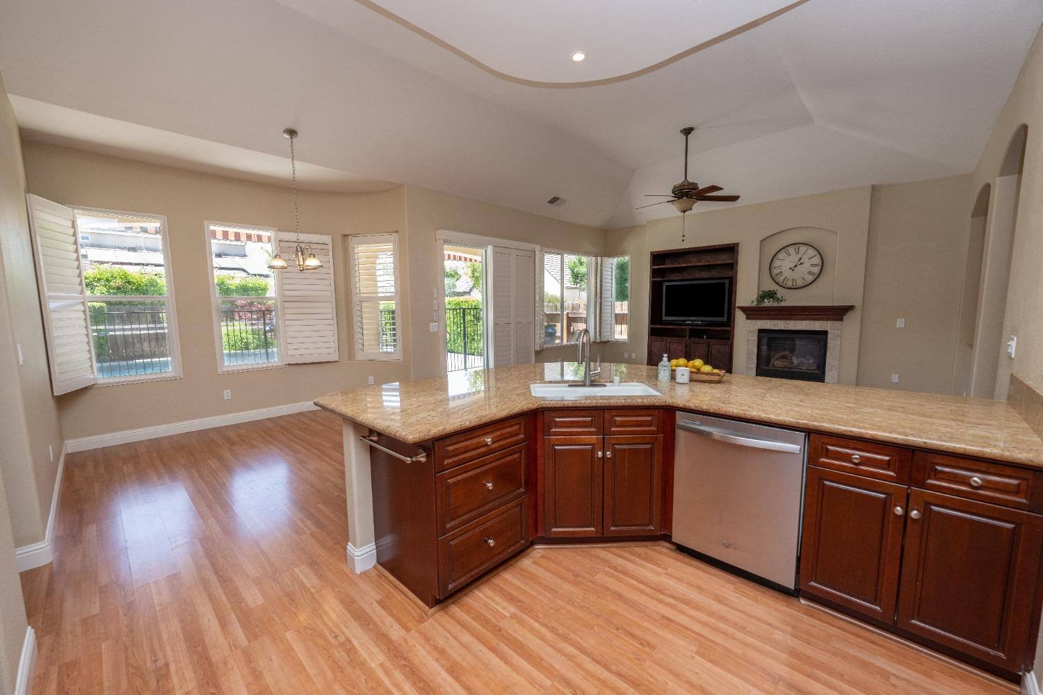 1778 Osmun Avenue Clovis, CA 93619 - Photo 15 of 35 a kitchen with wooden floors and wooden cabinets