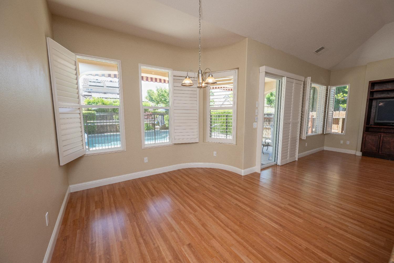 1778 Osmun Avenue Clovis, CA 93619 - Photo 17 of 35 a view of an empty room with wooden floor and a window