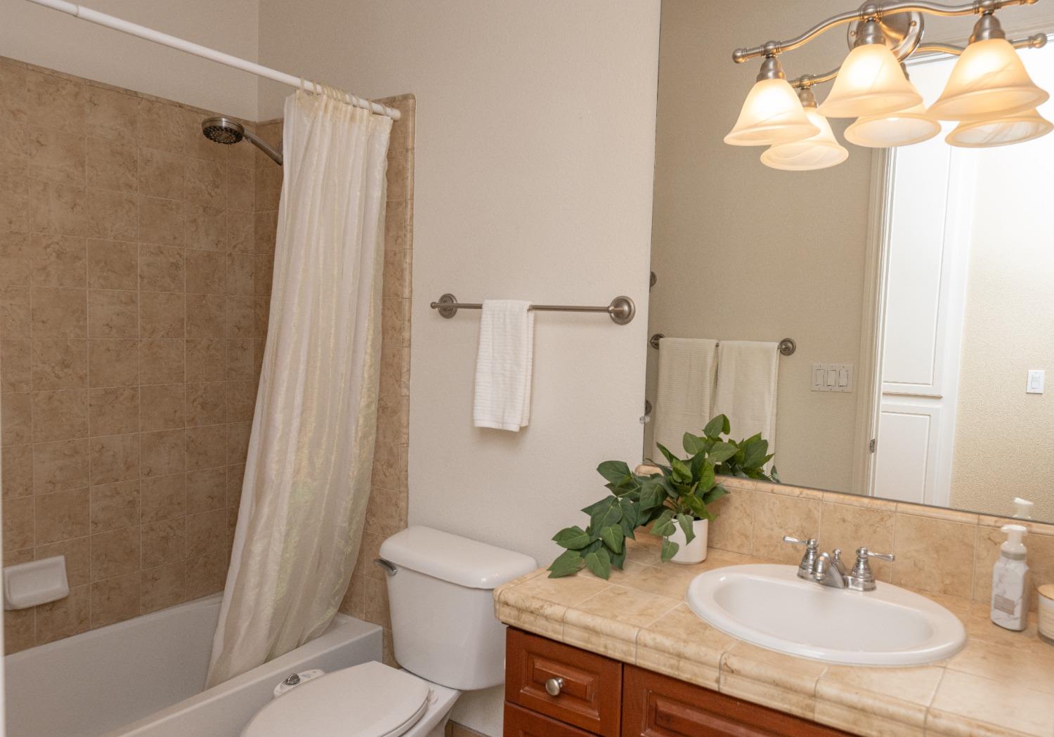 1778 Osmun Avenue Clovis, CA 93619 - Photo 20 of 35 a bathroom with a granite countertop sink toilet and shower