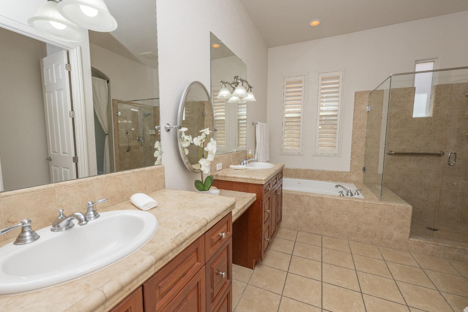 1778 Osmun Avenue Clovis, CA 93619 - Photo 24 of 35 a bathroom with a granite countertop sink a mirror and a bathtub