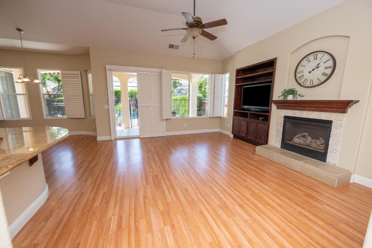 1778 Osmun Avenue Clovis, CA 93619 - Photo 9 of 35 a view of an empty room with wooden floor fireplace and a window