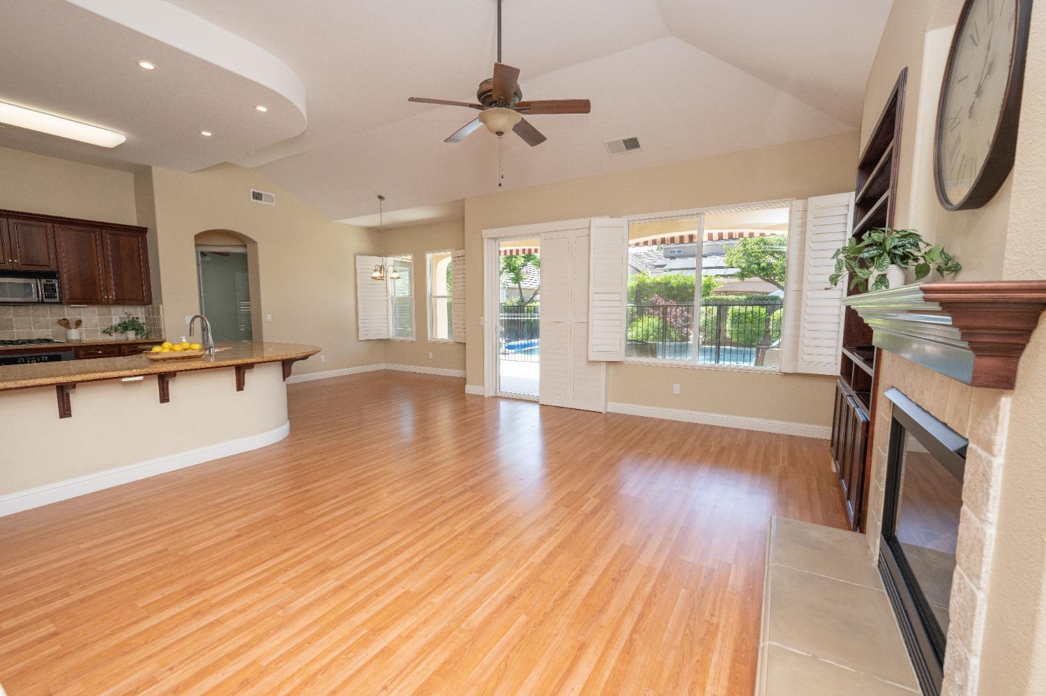 1778 Osmun Avenue Clovis, CA 93619 - Photo 10 of 35 a living room with stainless steel appliances granite countertop furniture wooden floor and a fireplace