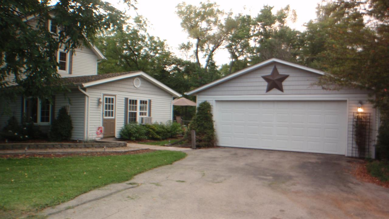 8009 Freeport Road Rockton, IL 61072 - Photo 23 of 25 a front view of a house with a yard and garage