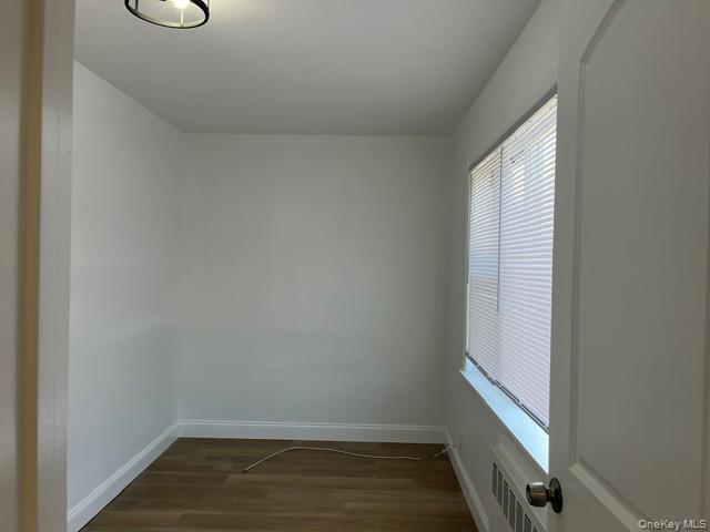46-05 158th Street Queens, NY 11358 - Photo 11 of 15 a view of a room with wooden floor and windows