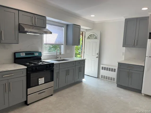 a kitchen with stainless steel appliances granite countertop a stove a sink and a refrigerator