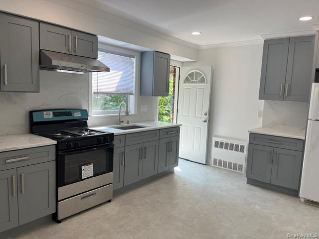 46-05 158th Street Queens, NY 11358 - Photo 8 of 15 a kitchen with stainless steel appliances granite countertop a stove a sink and a refrigerator