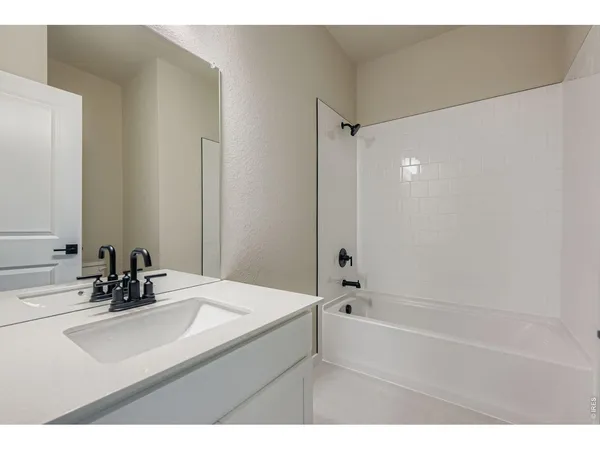a bathroom with a bathtub and a sink