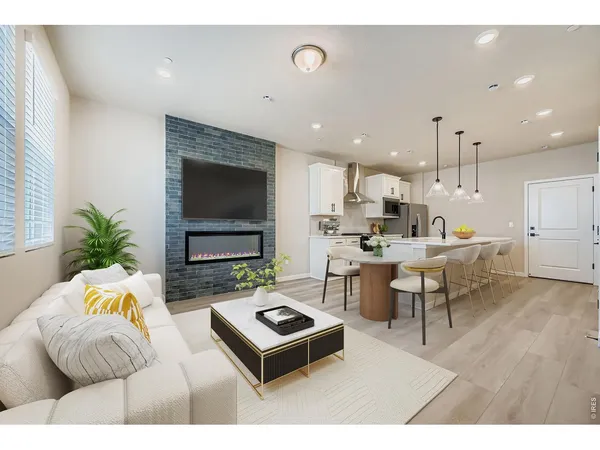 a living room with patio furniture and a flat screen tv