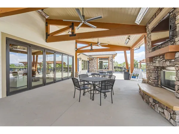 a dining room with furniture and a floor to ceiling window