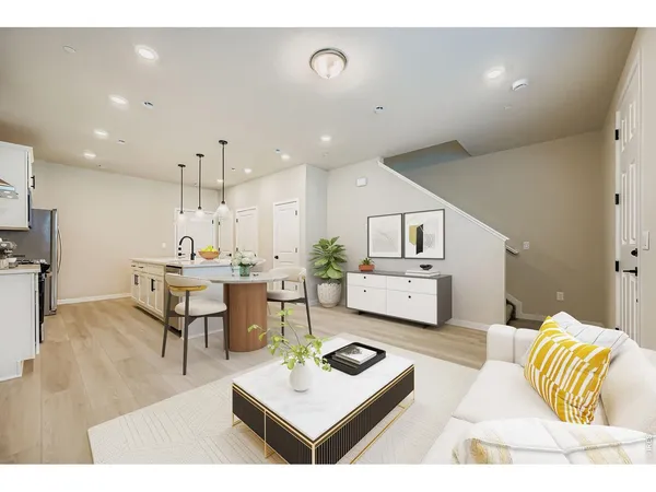 a living room with furniture and kitchen view