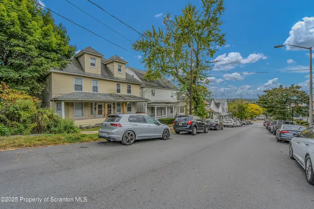 a car parked in front of a white house