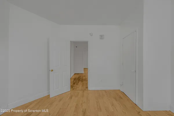 a view of a room with wooden floor