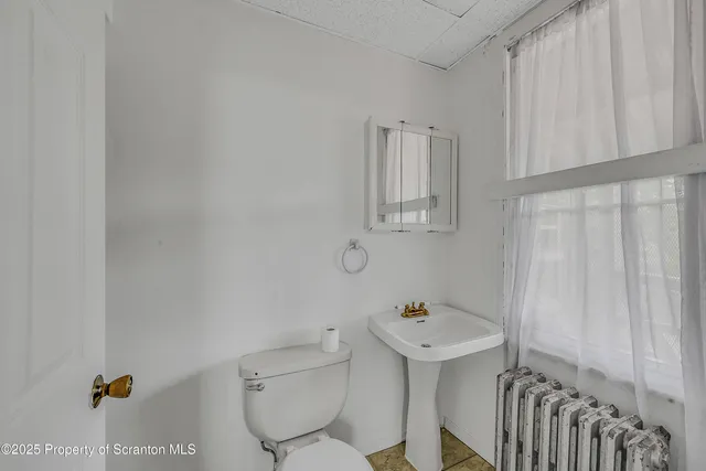 a bathroom with a sink toilet and mirror