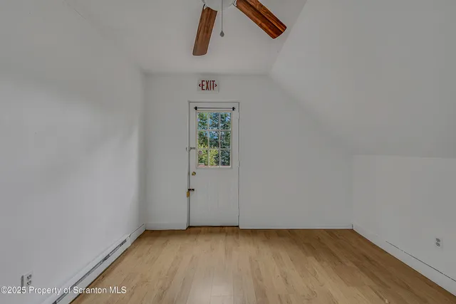 a view of room with hardwood floor and window