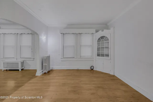 a view of a livingroom with an empty space and a window