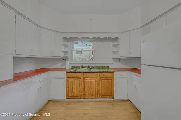 a kitchen with stainless steel appliances granite countertop a sink and cabinets