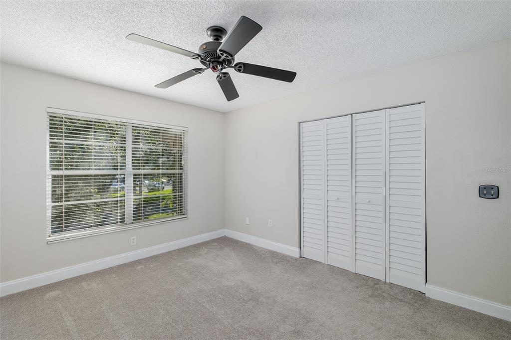 7900 Hardwick Drive, Unit 827 New Port Richey, FL 34653 - Photo 20 of 27 a view of a livingroom with a ceiling fan and window