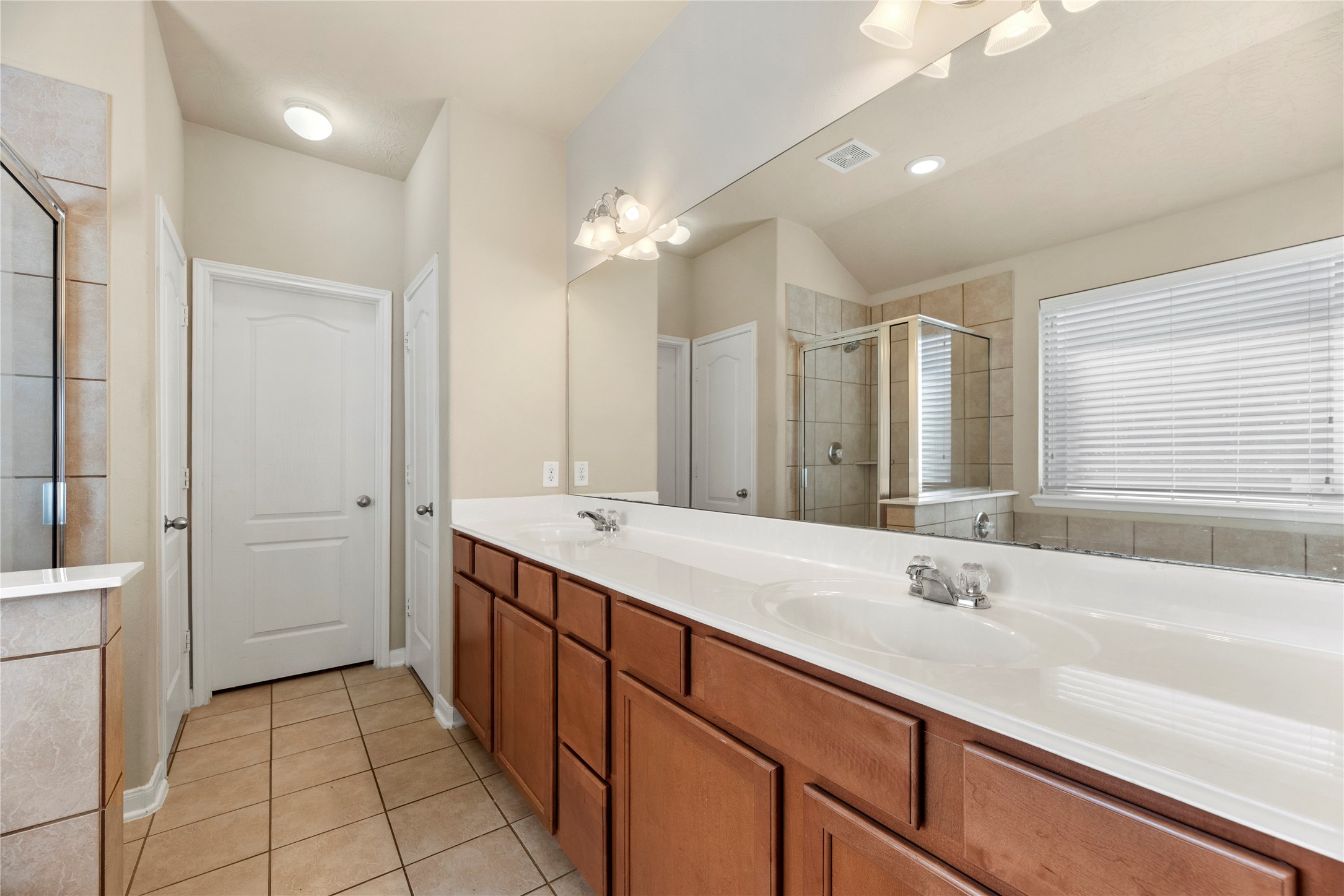 3311 Sabine Spring Lane Katy, TX 77449 - Photo 8 of 16 The ensuite Primary Bath is designed for convenience featuring a long vanity with double sinks and plenty of storage.