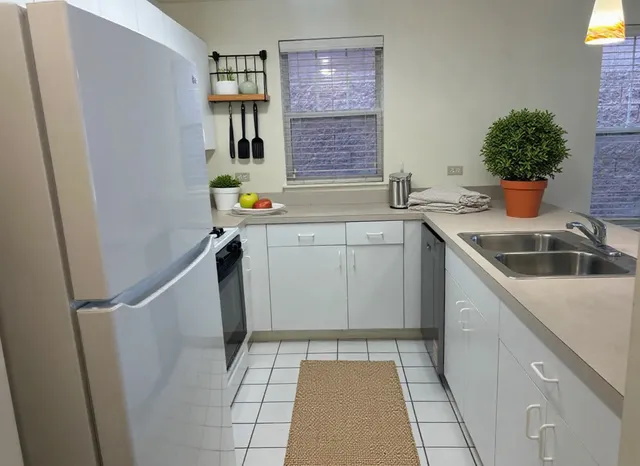 a kitchen with a sink and refrigerator