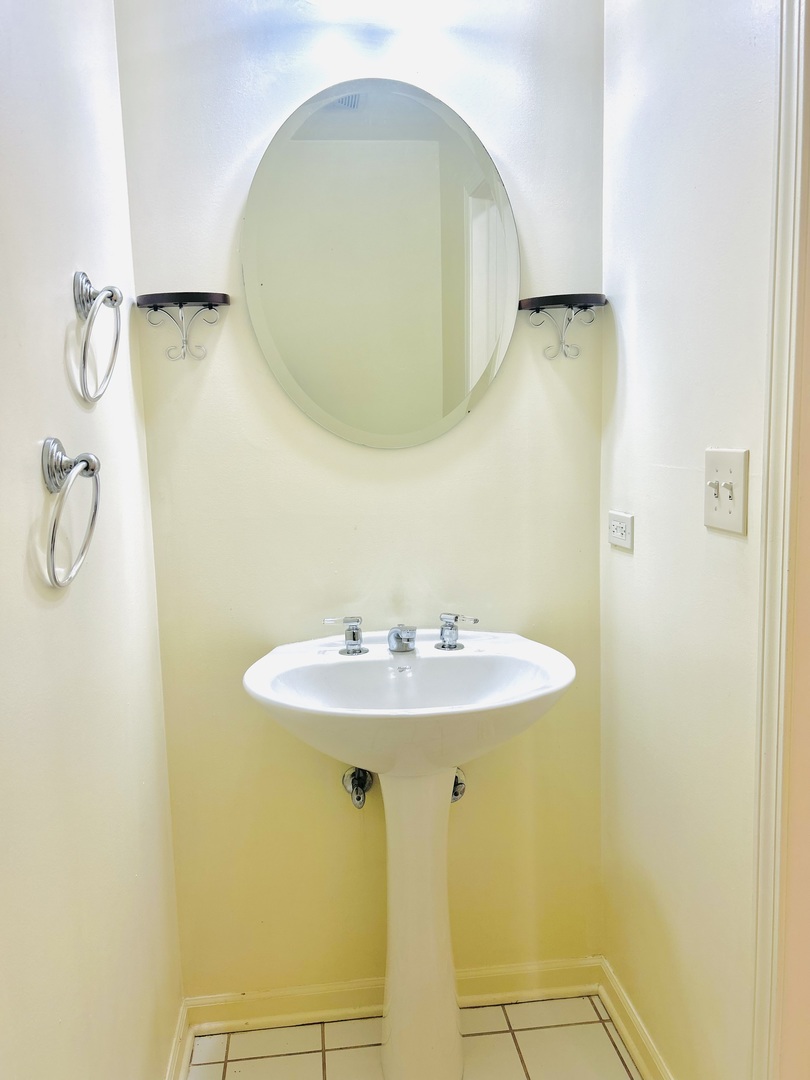 653 West Division Street, Unit B Chicago, IL 60610 - Photo 8 of 13 a bathroom with a sink and a mirror