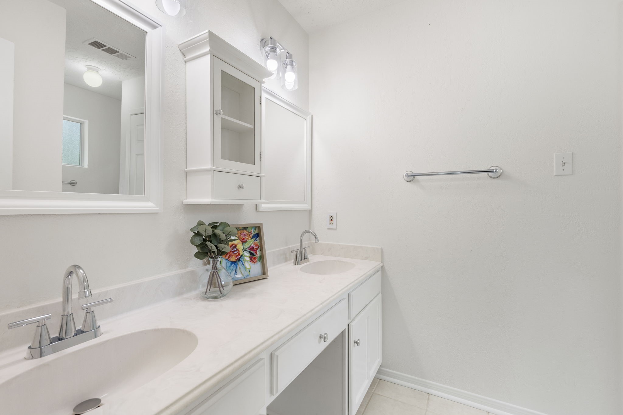 4715 Towermont Lane Spring, TX 77388 - Photo 17 of 35 The primary bathroom boasts double sinks, fresh lighting and new paint.