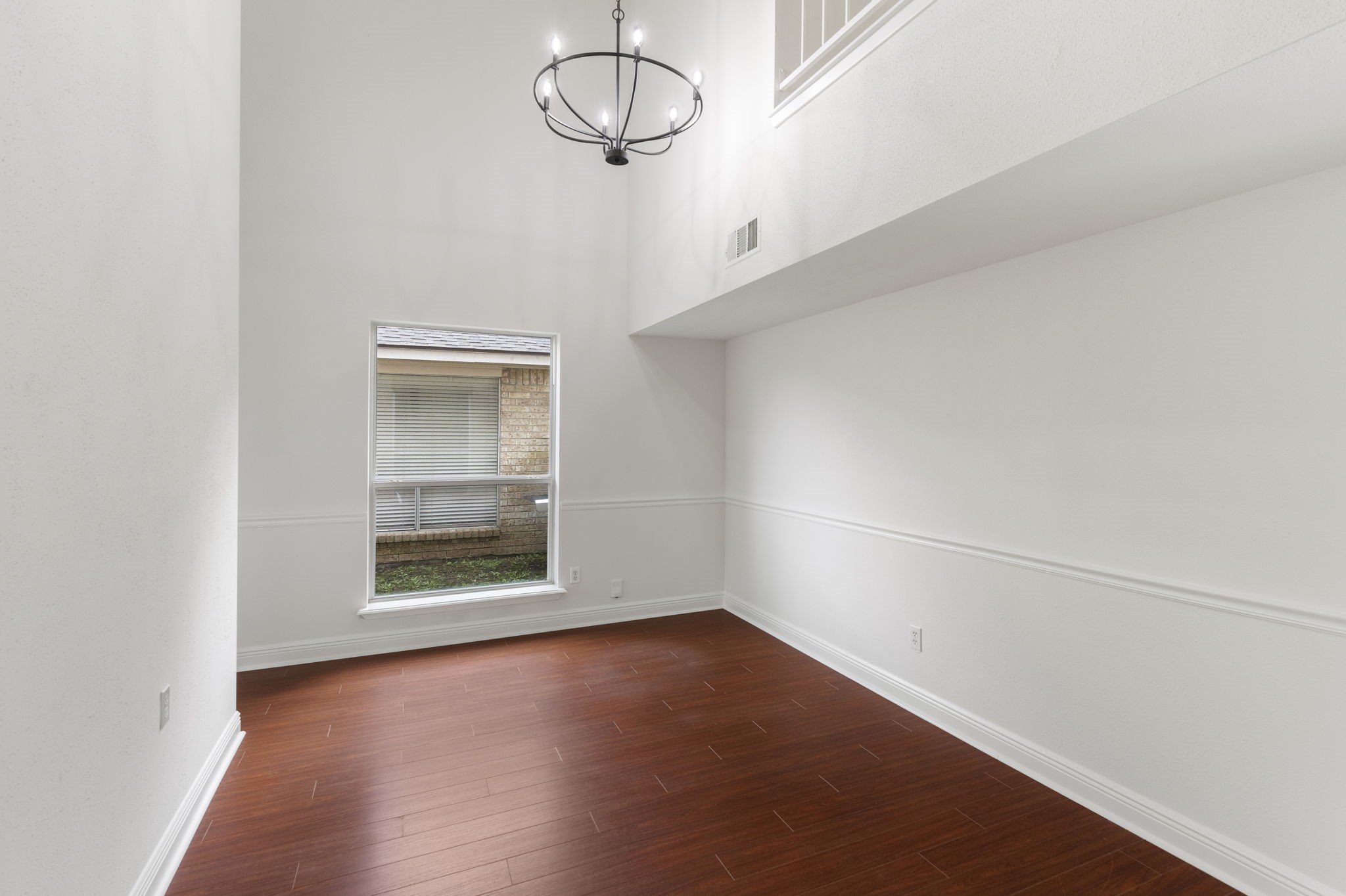 4715 Towermont Lane Spring, TX 77388 - Photo 5 of 35 2-story dining room with fresh paint and chair rail is just a step away from the kitchen, making dinner parties a breeze.