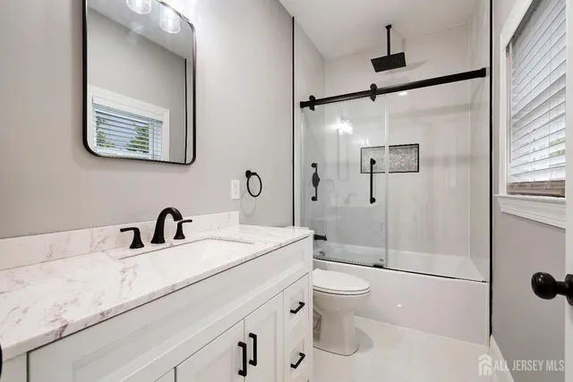 a spacious bedroom with a bed and a flat screen tv