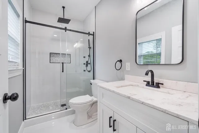 a spacious bedroom with a bed and wooden floor