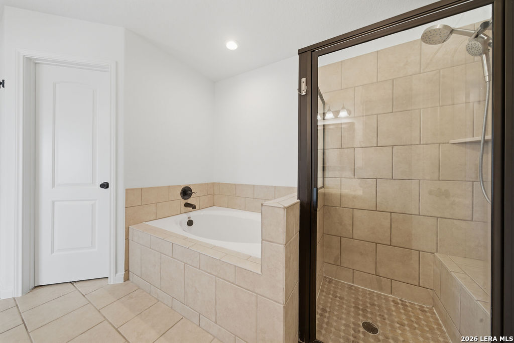 12897 La Vernia Road St. Hedwig, TX 78152 - Photo 22 of 34 a bathroom with a bathtub and shower