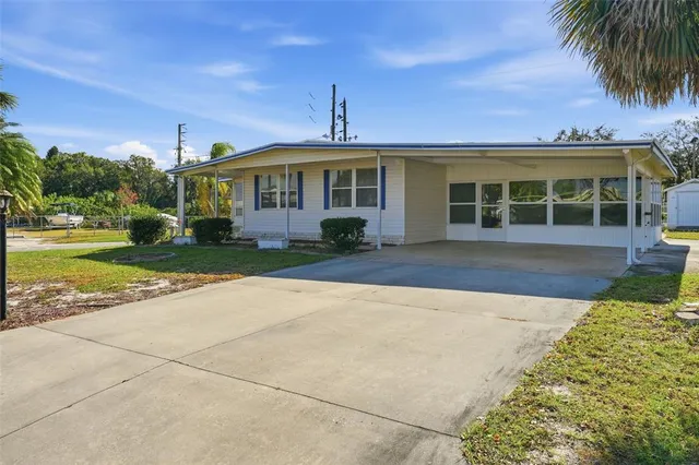 a front view of a house with a garden and yard
