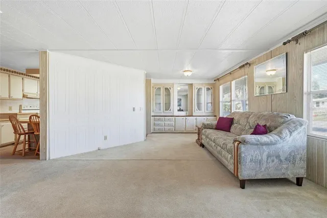 a view of a kitchen with kitchen island a counter top space a sink stainless steel appliances and cabinets