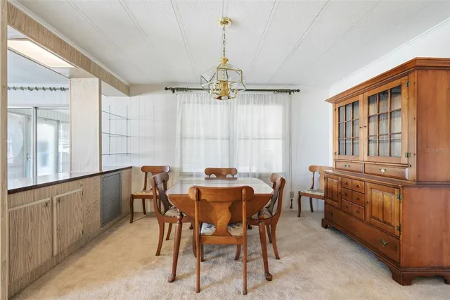 a dining room with furniture and window