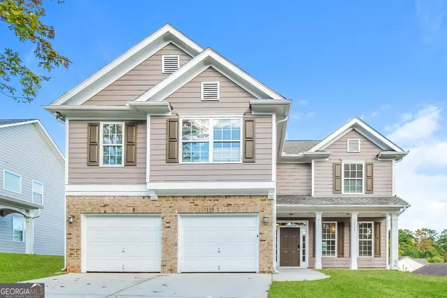 a front view of a house with garden