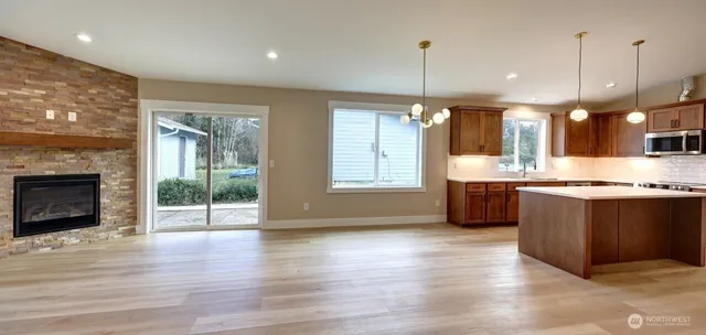a view of kitchen with granite countertop window and a sink
